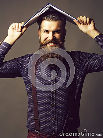 Man with journal on head Stock Photo