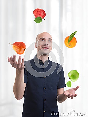 Man juggle fruits Stock Photo