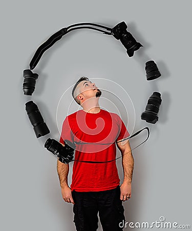 Man Juggling Cameras and Lenses with mind Stock Photo