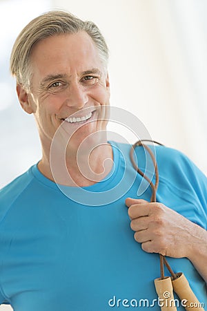 Man With Jump Rope Smiling In Health Club Stock Photo