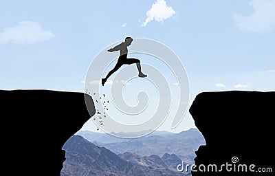 Man jumping over abyss. Stock Photo