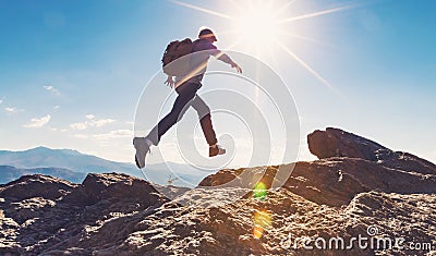 Man jumping over gap on mountain hike Stock Photo