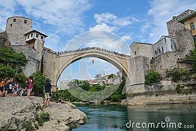 Man jumping from a very high ancient bridge in Mostar Editorial Stock Photo
