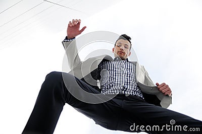 Man jumping and wearing jacket and shirt Stock Photo