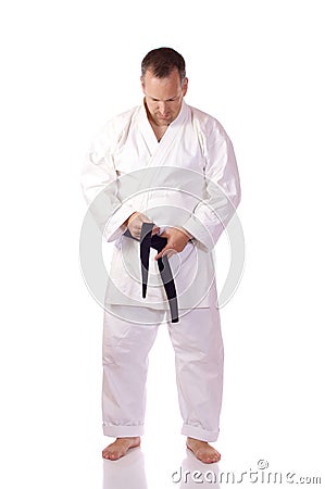 Karateka fastening his belt Stock Photo