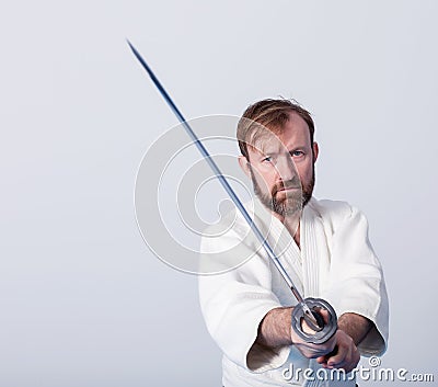 A man with katana is ready to attack Stock Photo