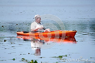 Retired man floating in a kayak Stock Photo