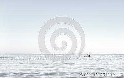 Man kayaking on the very calm water on the sea. Man kayaking in the early afternoon on the Aegean sea, Greece Stock Photo