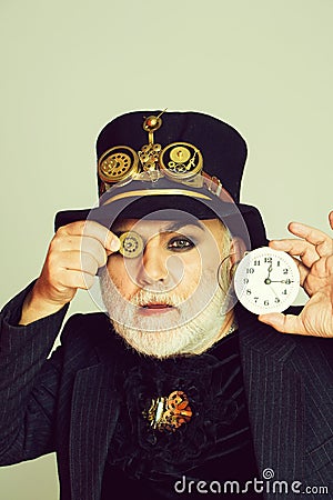 Man keeps cogwheel and clock Stock Photo