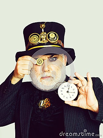 Man keeps cogwheel and clock Stock Photo