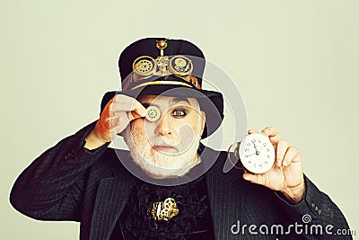 Man keeps cogwheel and clock Stock Photo