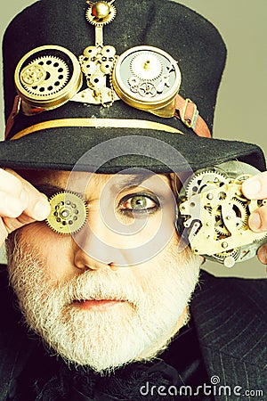 Man keeps cogwheel and gears Stock Photo