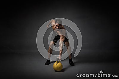 Man with kettleball on hand Stock Photo