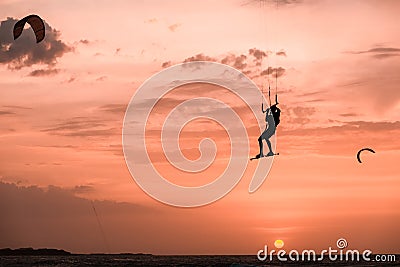 Man kitesurfer athlete jumping at sunset, silhouette at dusk man doing kitesurfing jump Editorial Stock Photo