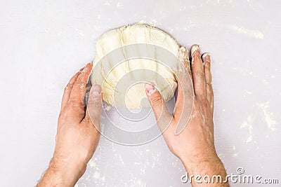 The man kneads the dough Stock Photo