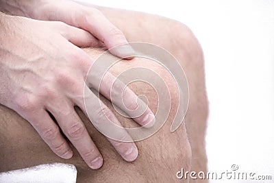 Man with knee pain and feeling bad in medical office. osteoarthritis joint pain after sport. Breaks and sprains of the Stock Photo