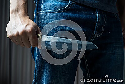 Man with a knife in a hand , in dark tone Stock Photo