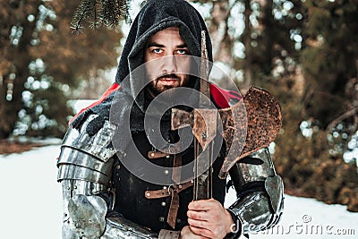 Man knight in historical clothing with an ax Stock Photo