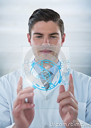 Man in lab coat holding up glass device with blue medical interface and flare against grey backgroun Stock Photo