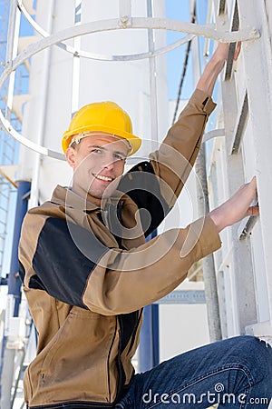 Man ladder poised to climb enclosed ladder Stock Photo
