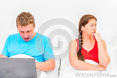 Man with a laptop and a frustrated wife Stock Photo