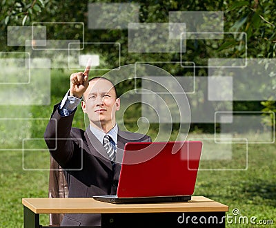 Man with laptop working outdoors Stock Photo