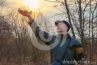 Man launching a drone against the rising sun Stock Photo