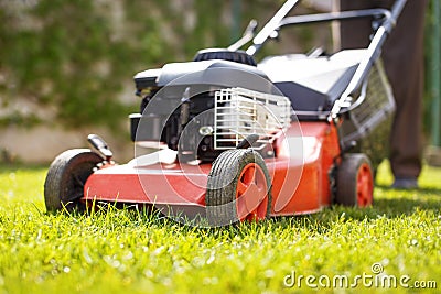 Man with lawnmower Stock Photo