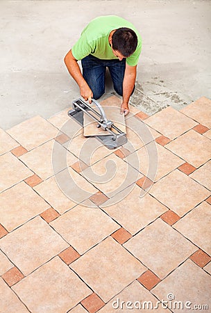 Man laying ceramic floor tiles Stock Photo