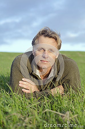 Man laying on the grass Stock Photo