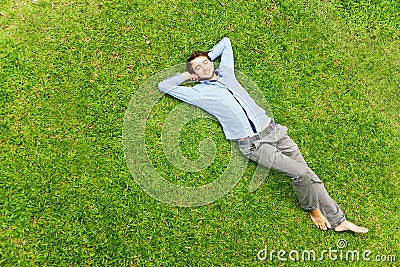 Man laying on a grass Stock Photo