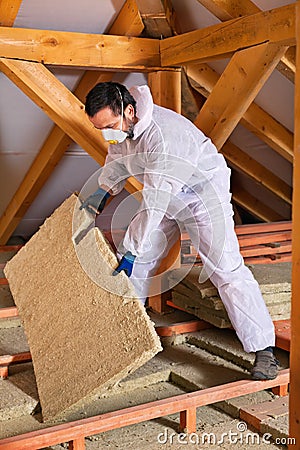 Man laying thermal insulation layer Stock Photo