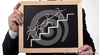 Man leading team image drawn on blackboard in businessman hands, cooperation Stock Photo