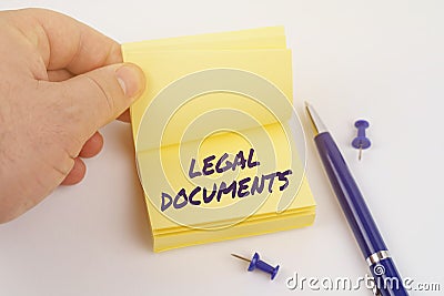 The man is leafing through the stickers the sheet says - LEGAL DOCUMENTS Stock Photo