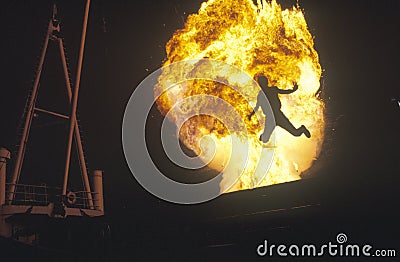 Man leaping through fireball Editorial Stock Photo