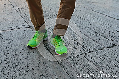 Man legs in socks and green sneakers Stock Photo