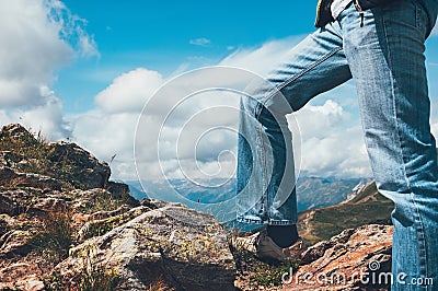 Man legs standing on top of cliff Stock Photo