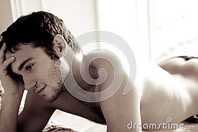 The man lies on a bed Stock Photo
