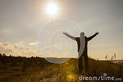 Man lifting his hands up silhouette background Stock Photo