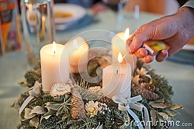 Man lighting candles of Advent wreath Stock Photo