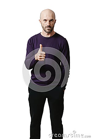 A man in a lilac sweater poses on a white background. He shows a hand gesture meaning like Stock Photo