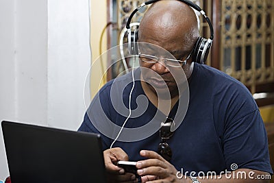 Man listening to the music and texting Stock Photo