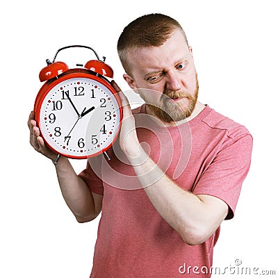 Man listening to the ticking of alarm clock Stock Photo