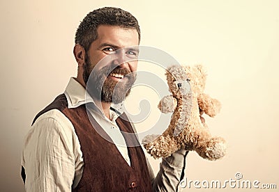 Man with long beard on happy face with bear toy Stock Photo