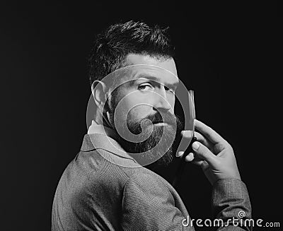 Man with long beard holds blade for razor. Barbershop advertising Stock Photo