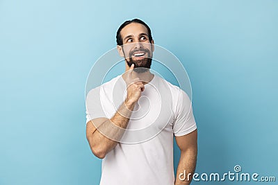 Man looking away with pensive expression, dreaming pleasant thoughts, fantasizing and making wish. Stock Photo