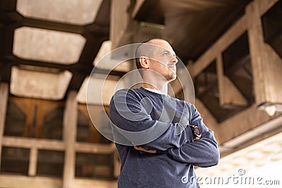 Man looking away standing under some urban building Stock Photo