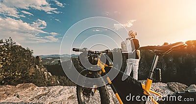 Man looking at beautiful misty mountains Enjoy panoramic mountain views. with bicycles ready to ride Cartoon Illustration