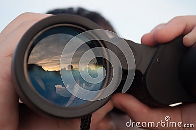 Man looking through binoculars Stock Photo