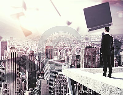 Man looking at city with laptop Stock Photo